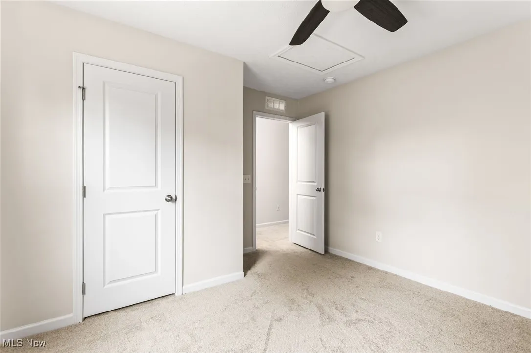Unfurnished bedroom with carpet floors and ceiling fan