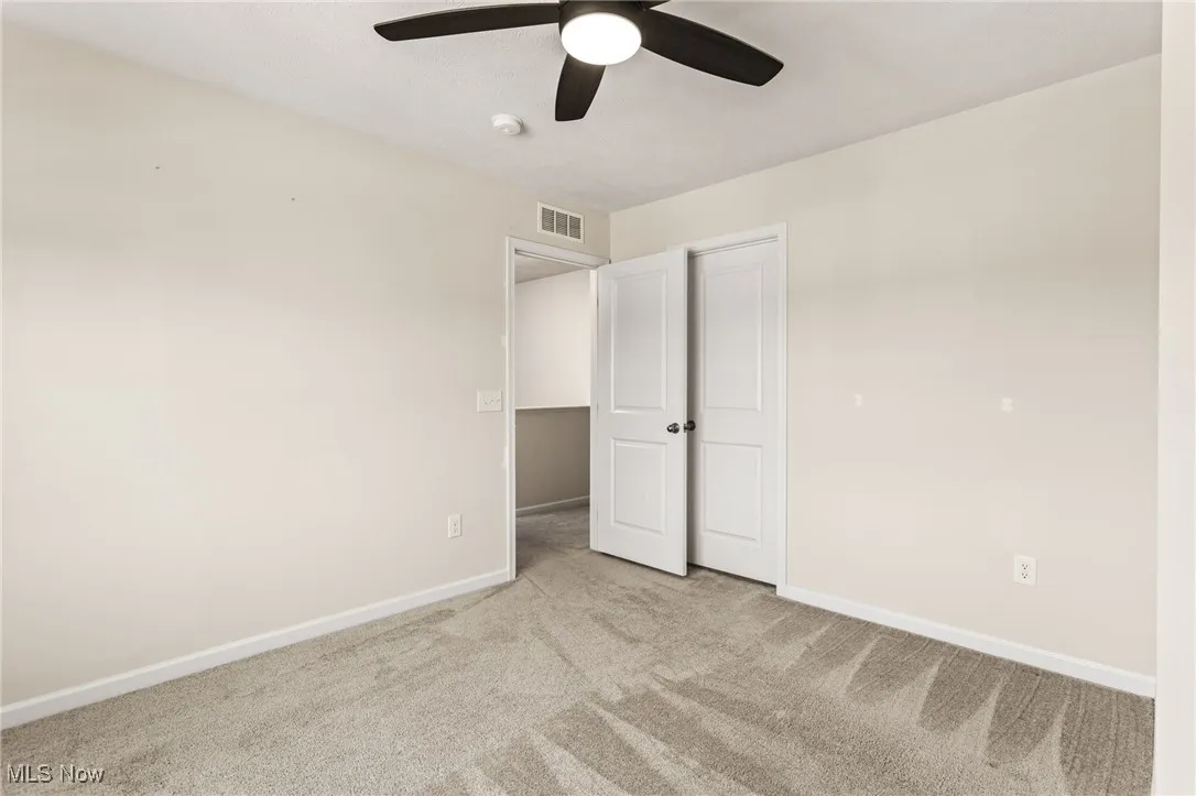 Unfurnished bedroom featuring carpet flooring and a ceiling fan