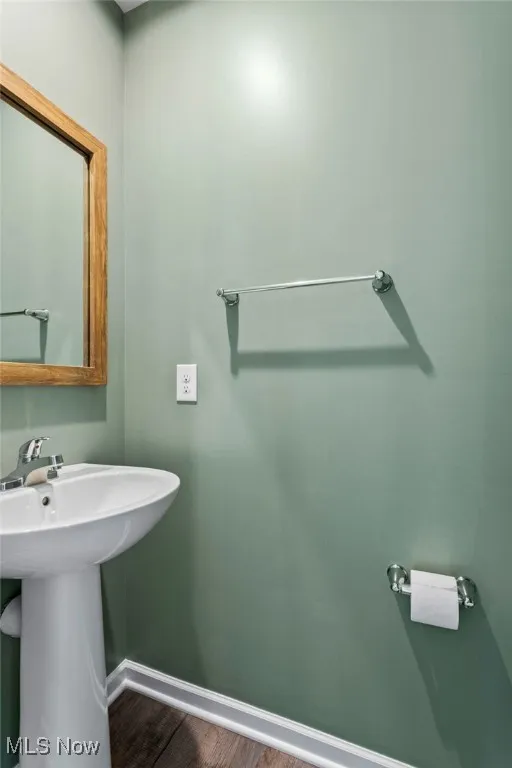 Bathroom with baseboards and wood finished floors