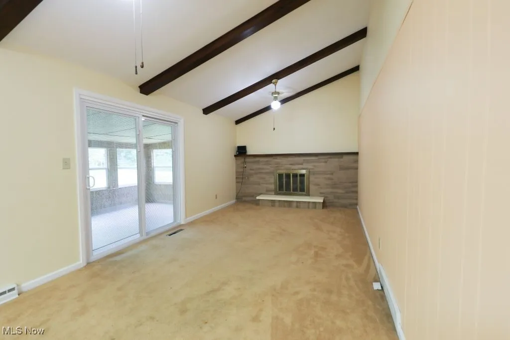 Family Room with Fireplace & Fans.  Cathedral Ceiling .   Sliding Glass Doors to the Sun Room