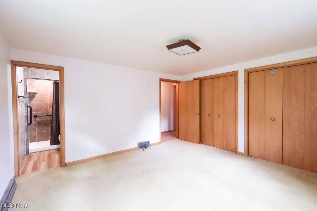 Primary Bedroom showing private shower and closets