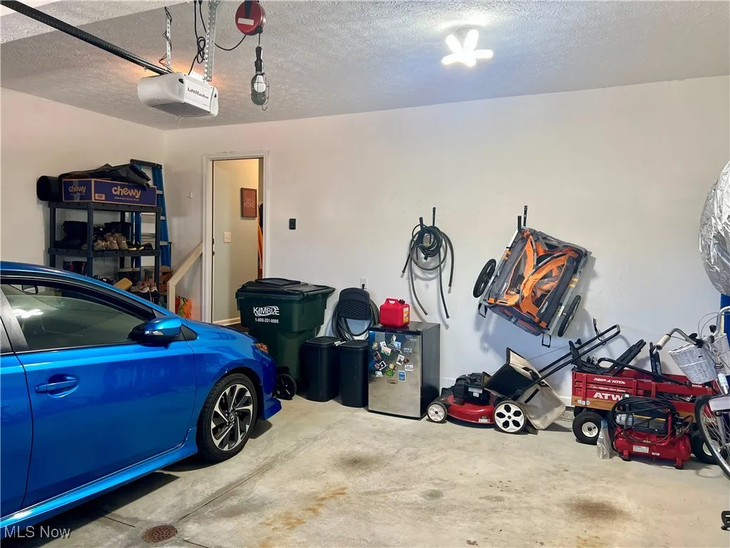 Garage featuring a garage door opener