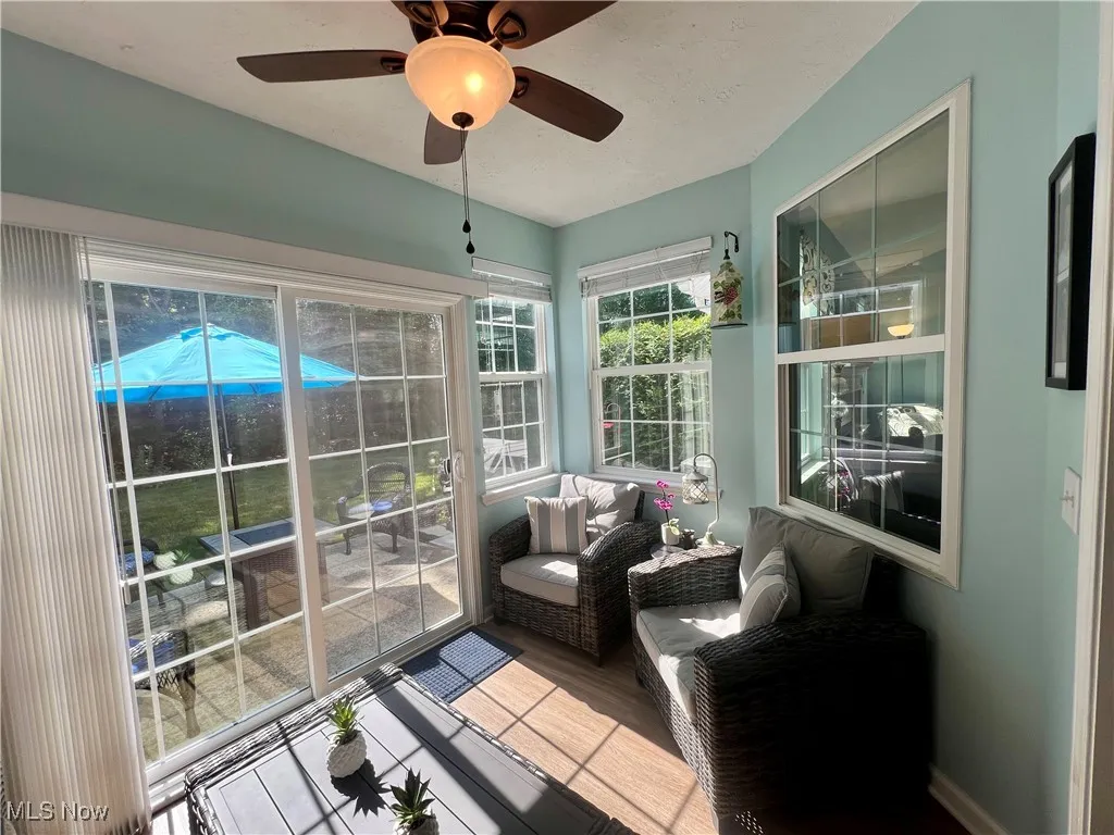 Sunroom featuring a ceiling fan