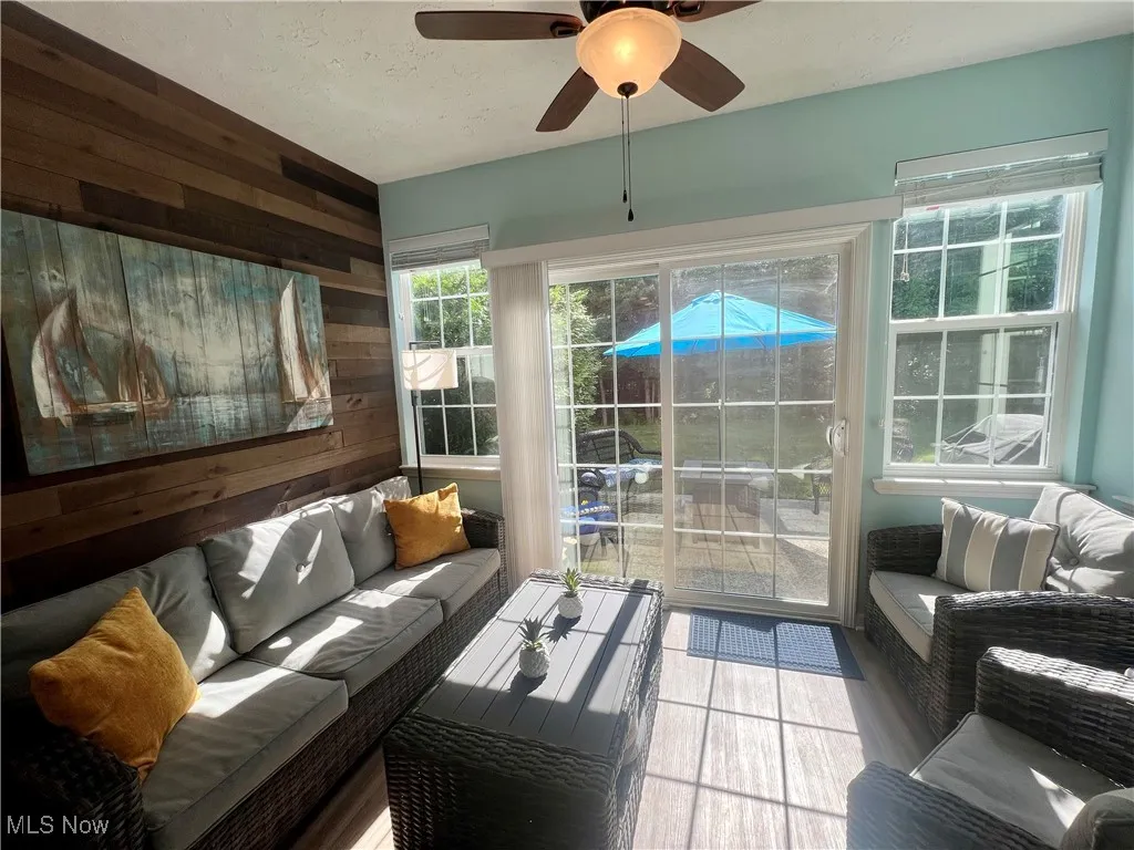 Sunroom featuring an outdoor living space and ceiling fan