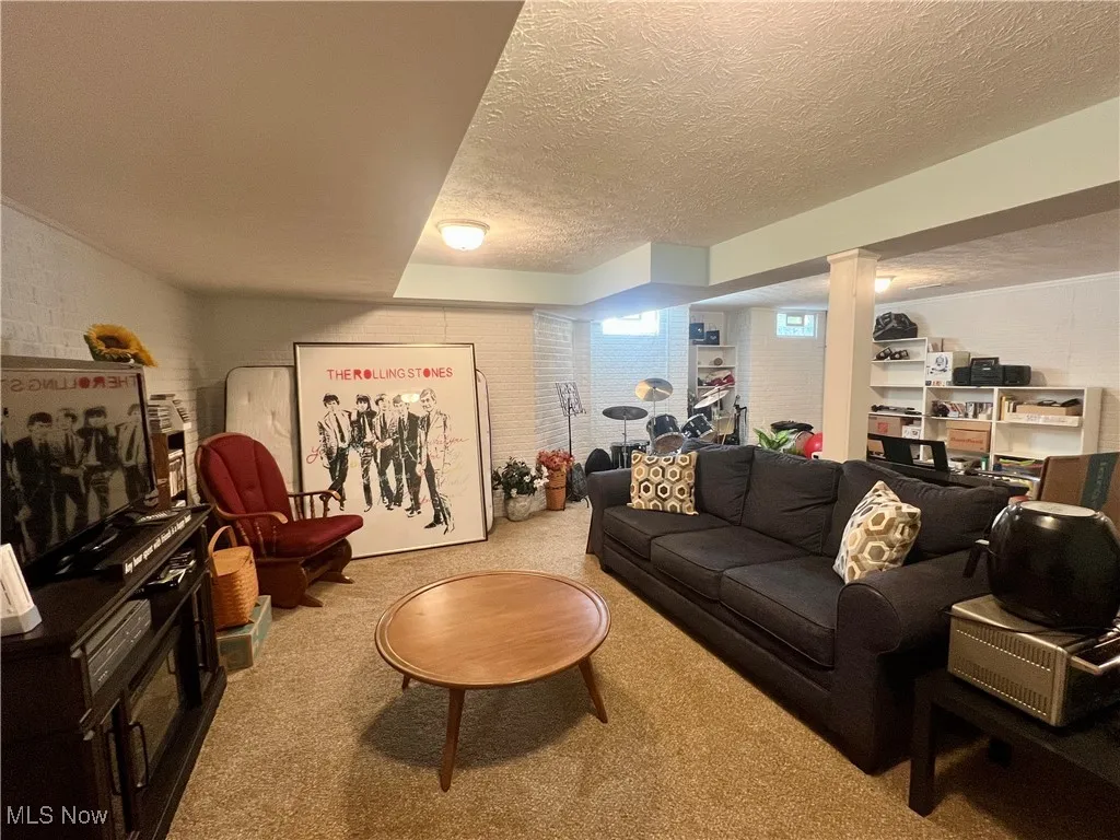 Living room with carpet floors and a textured ceiling
