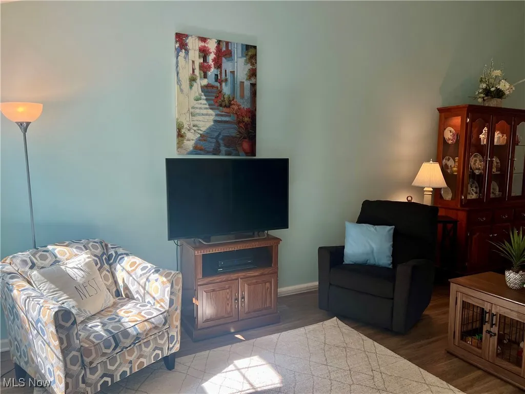 Living area with wood finished floors and baseboards