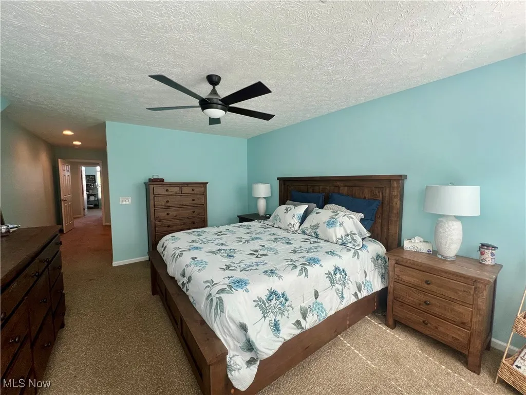 Bedroom with carpet floors, ceiling fan, a textured ceiling, and recessed lighting