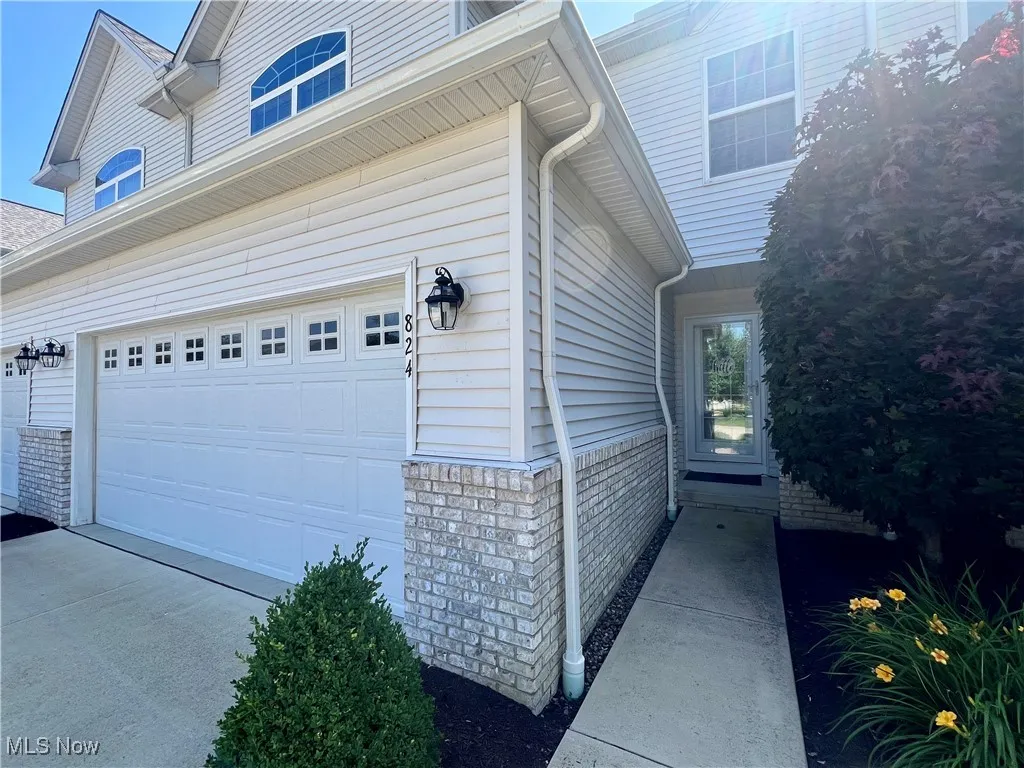 View of property exterior with a garage