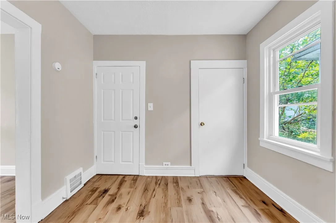 Entrance foyer featuring healthy amount of natural light and light wood-style floors