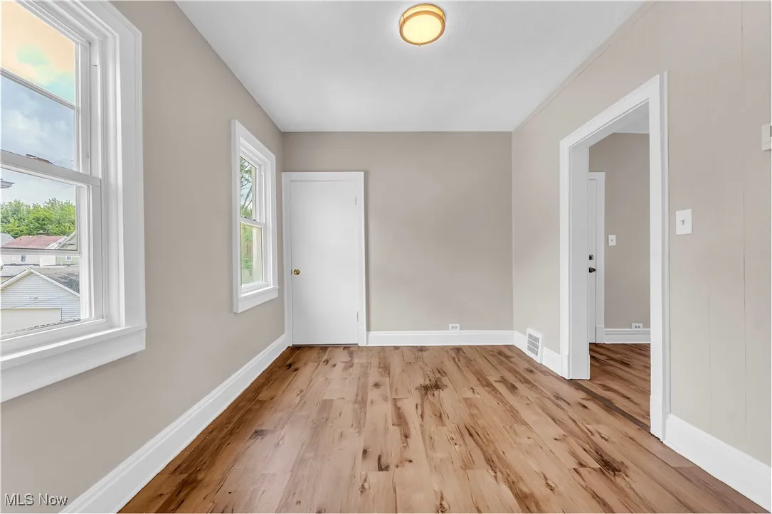 Empty room with light wood-style floors and baseboards