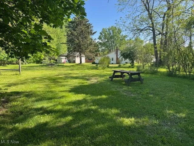 View of property's community with a yard