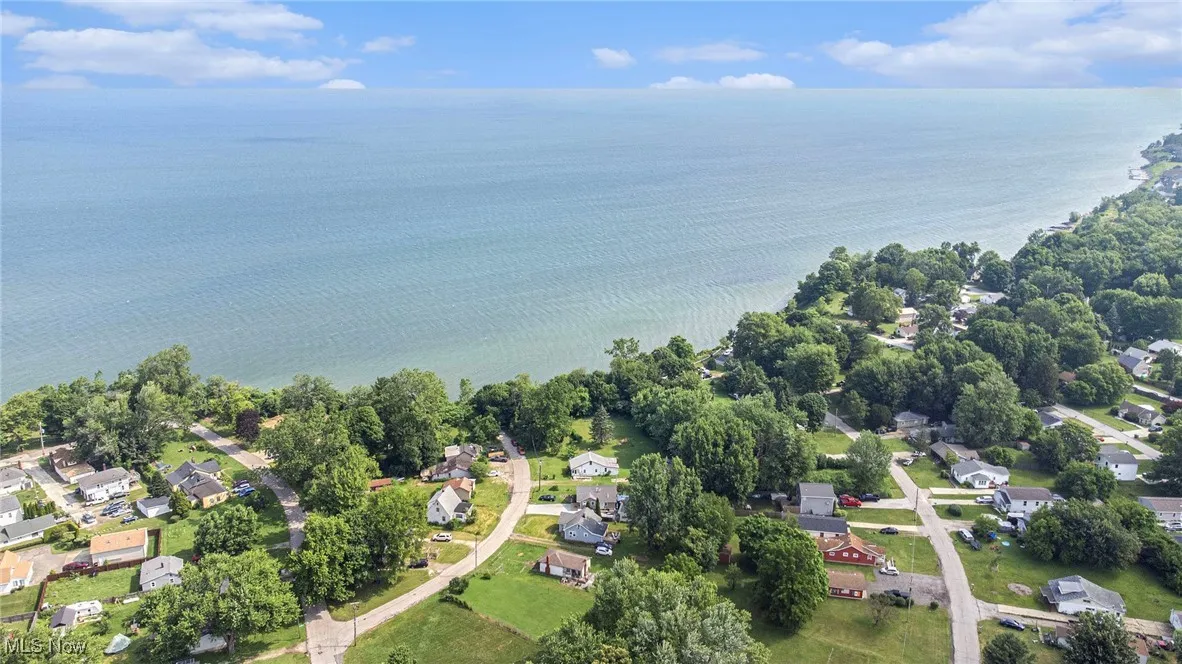 View of property location featuring a nearby body of water and nearby suburban area