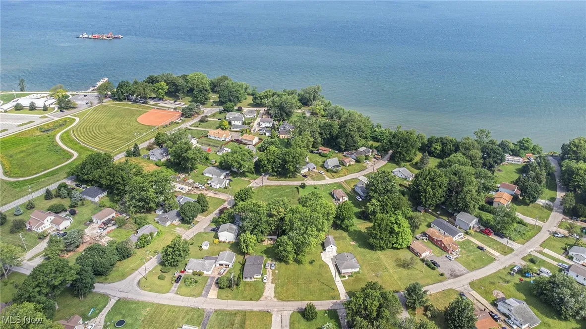 Aerial view of property and surrounding area featuring a nearby body of water