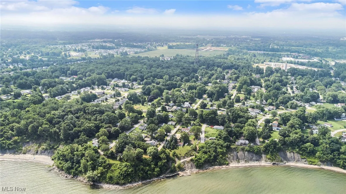 Aerial view of property and surrounding area with a large body of water
