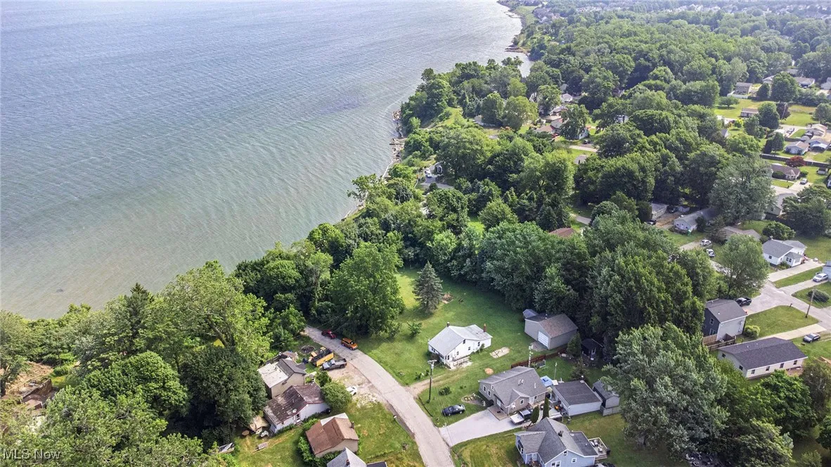 Aerial view of property's location featuring nearby suburban area and a nearby body of water