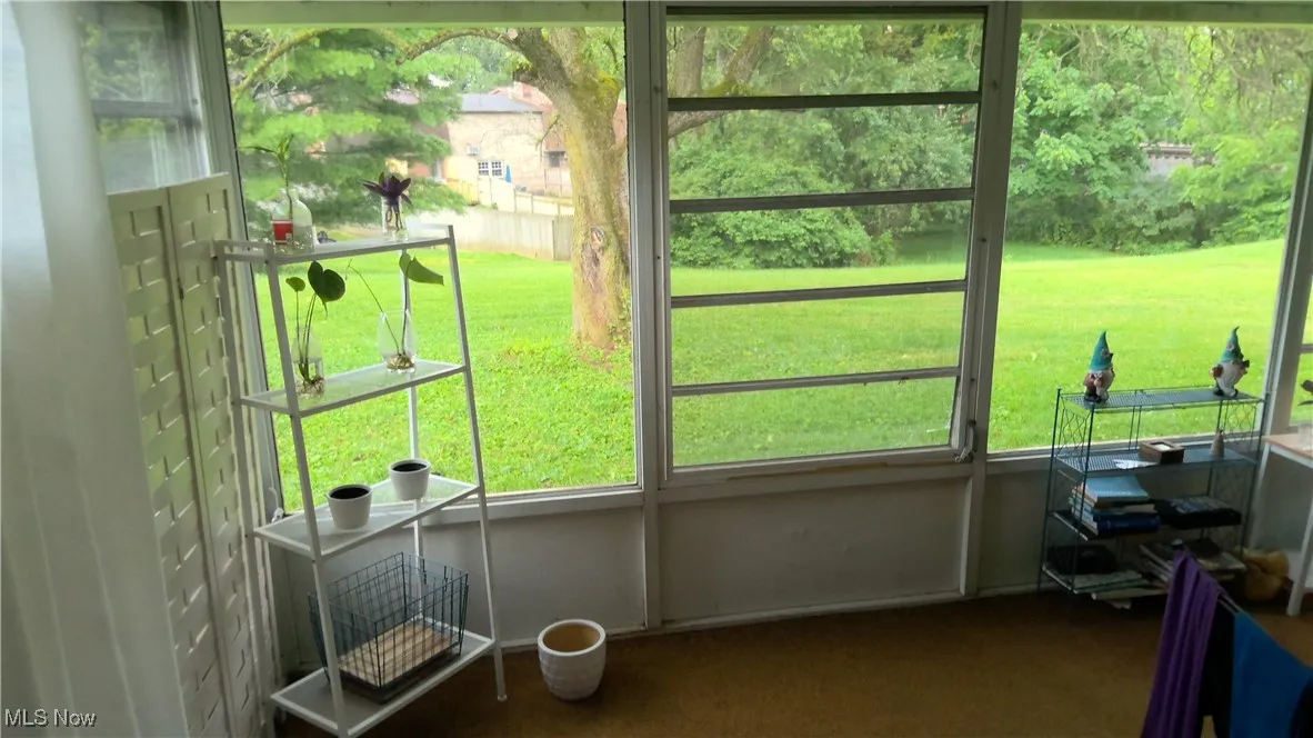 Unfurnished sunroom featuring plenty of natural light