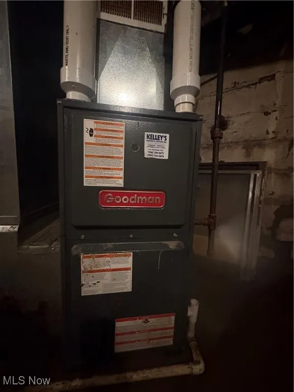 Utility room featuring heating unit