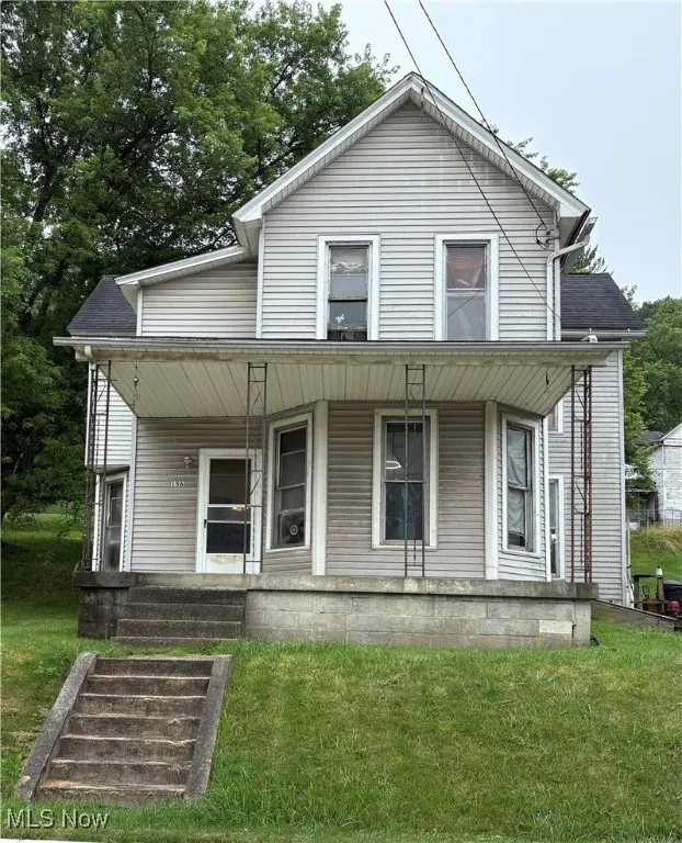 View of front facade with a porch and a front yard