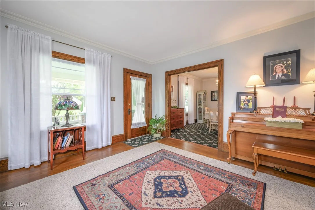 Living room with wood finished floors, natural woodwork and an abundance of natural light .