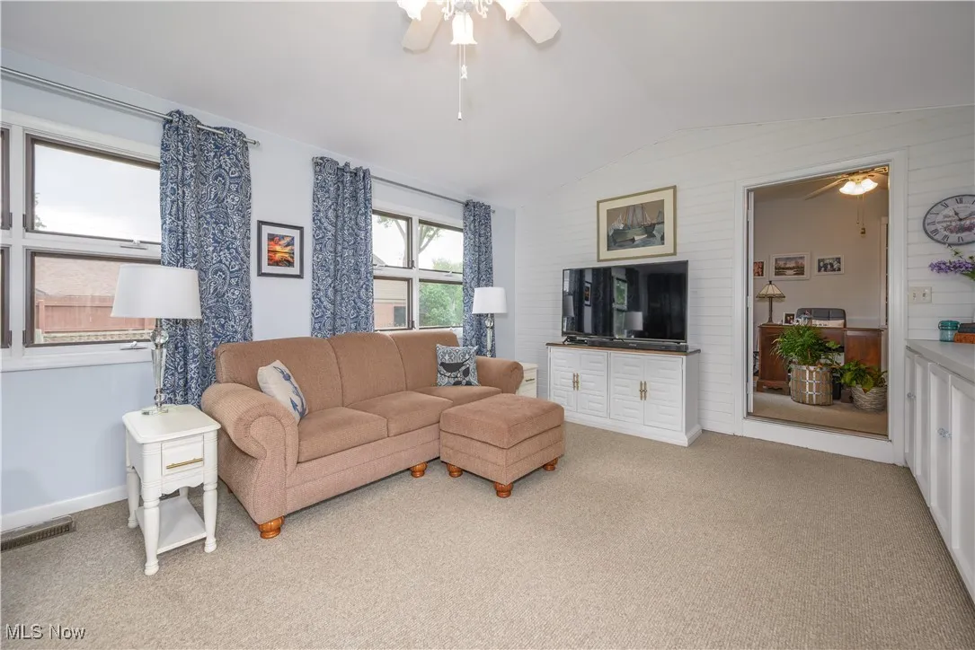 Family/sunroom with a view into the private office.  Great storage with the built-in cabinets along the sidewall.