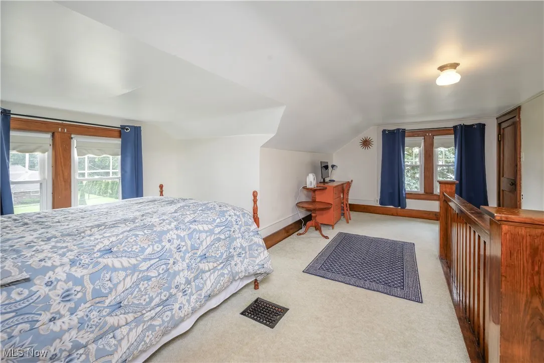 4th Bedroom on the 3rd floor...lots of natural light from multiple windows, and vaulted ceiling. Door on the right is a closet.