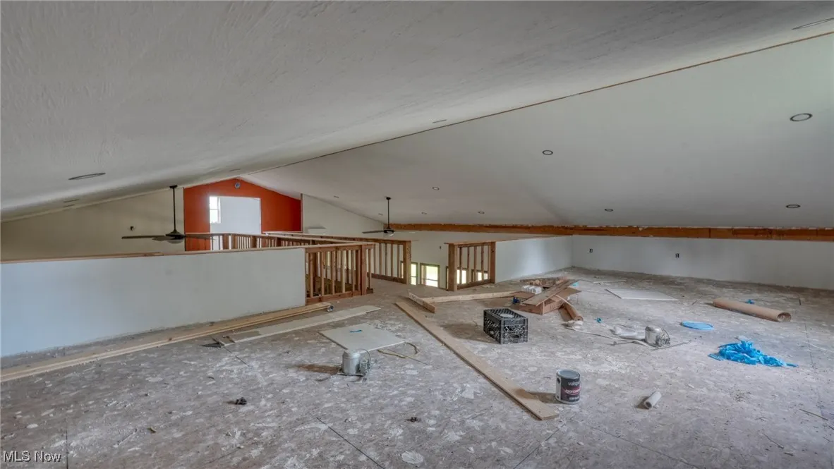 Bonus room with a ceiling fan and vaulted ceiling