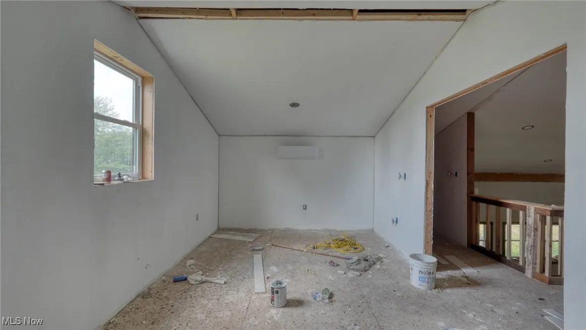 Unfurnished room featuring a wall mounted air conditioner