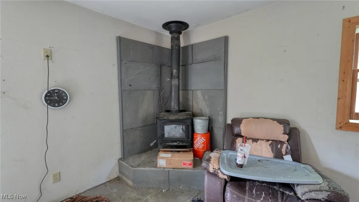 Detailed view of a wood stove and unfinished concrete flooring