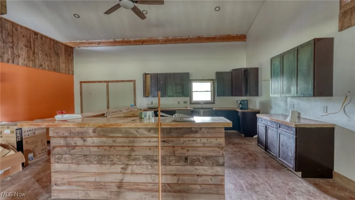 Kitchen with ceiling fan and a kitchen island with sink