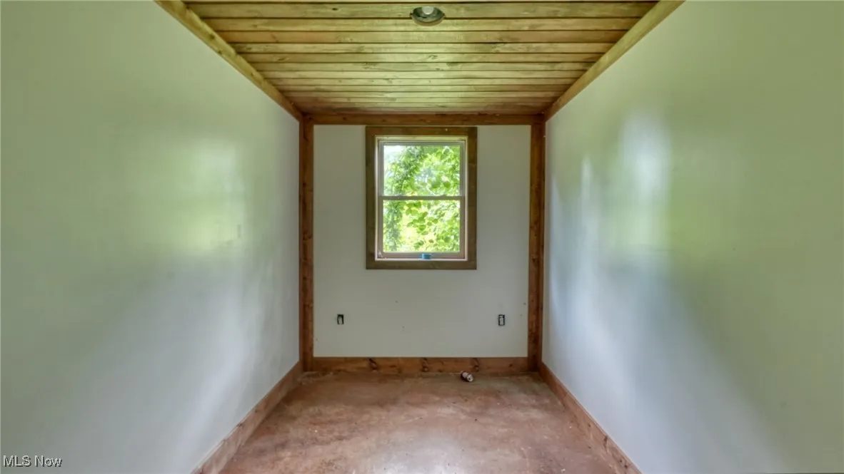 Spare room with wood ceiling and baseboards