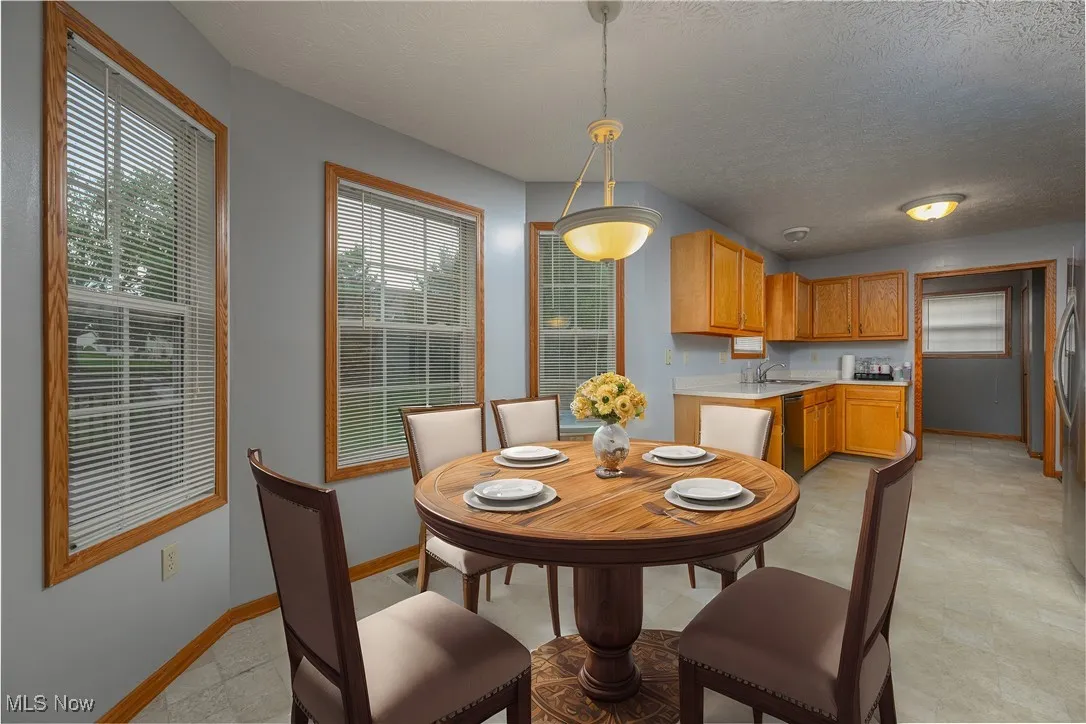 Dining area featuring a textured ceiling and sink