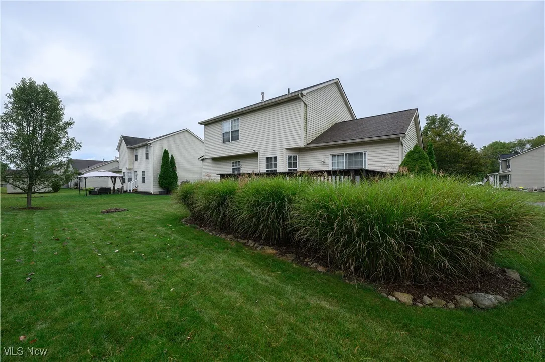 Rear view of property with a lawn