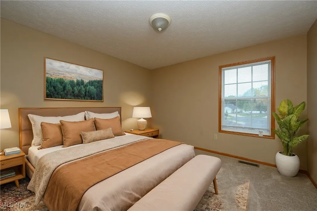 Bedroom featuring a textured ceiling and carpet flooring