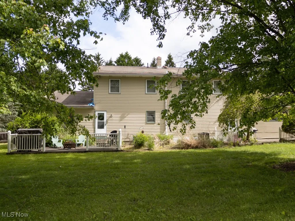 Back of house featuring a yard and a chimney