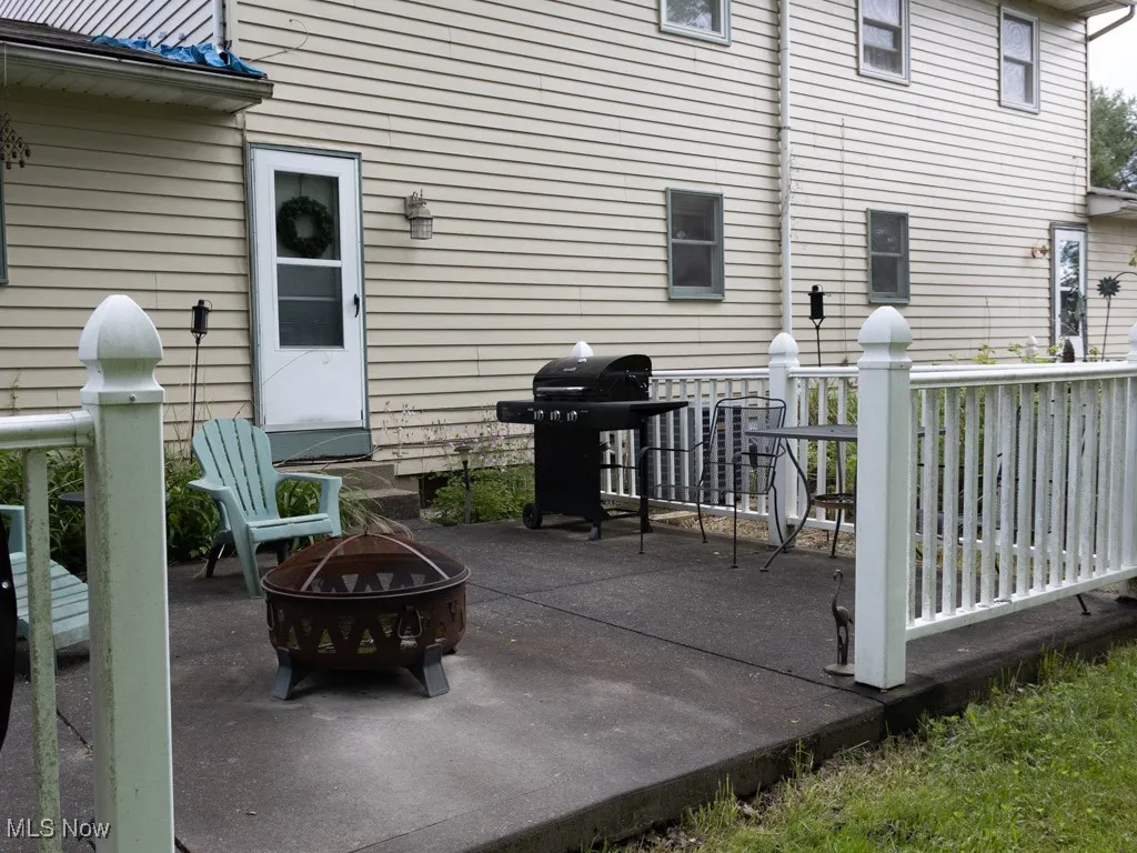 View of patio / terrace with a fire pit, a grill, and a deck