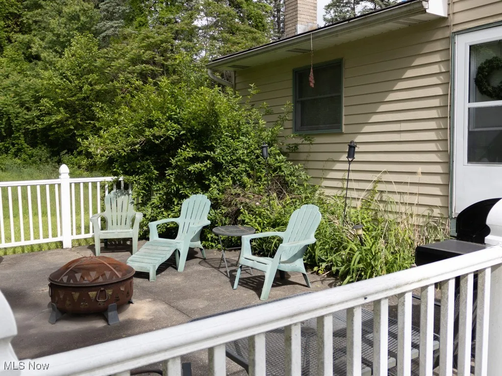 View of patio featuring an outdoor fire pit