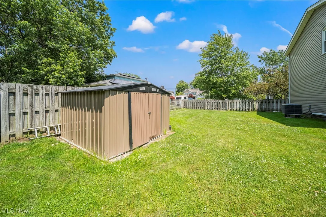 Fenced backyard with a shed