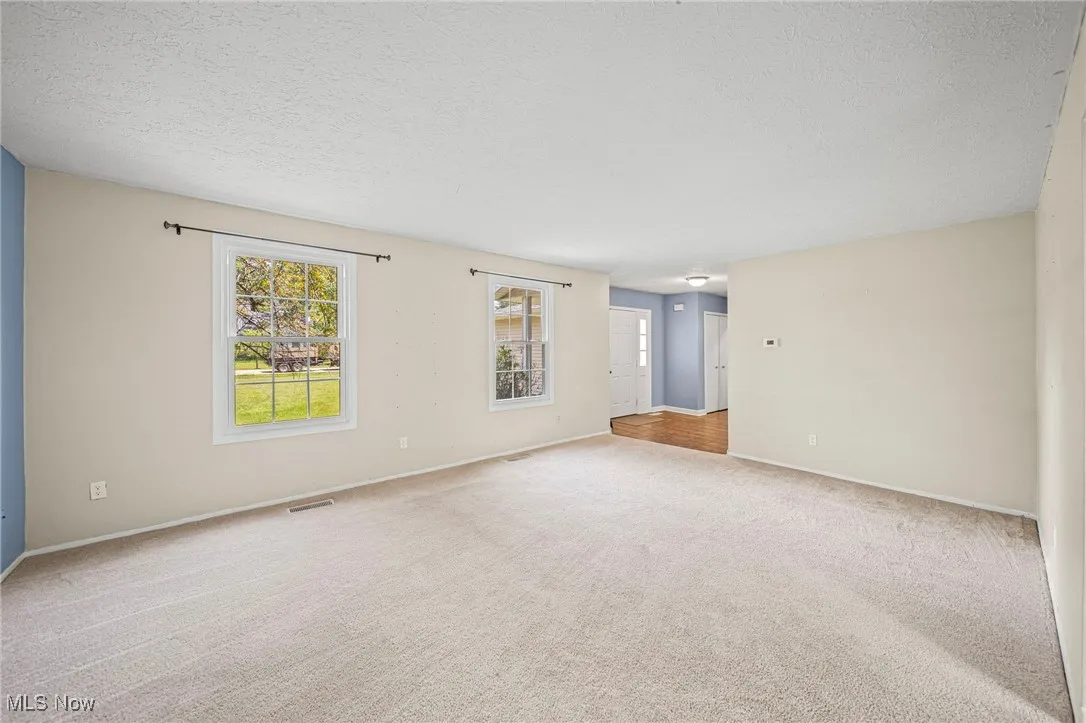 Spare room with carpet flooring and a textured ceiling