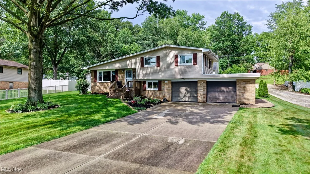 Tri-level home with concrete driveway and an attached garage