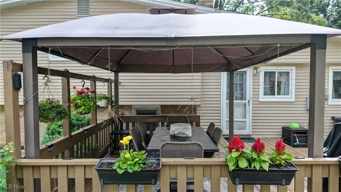 Deck featuring a gazebo and outdoor dining area