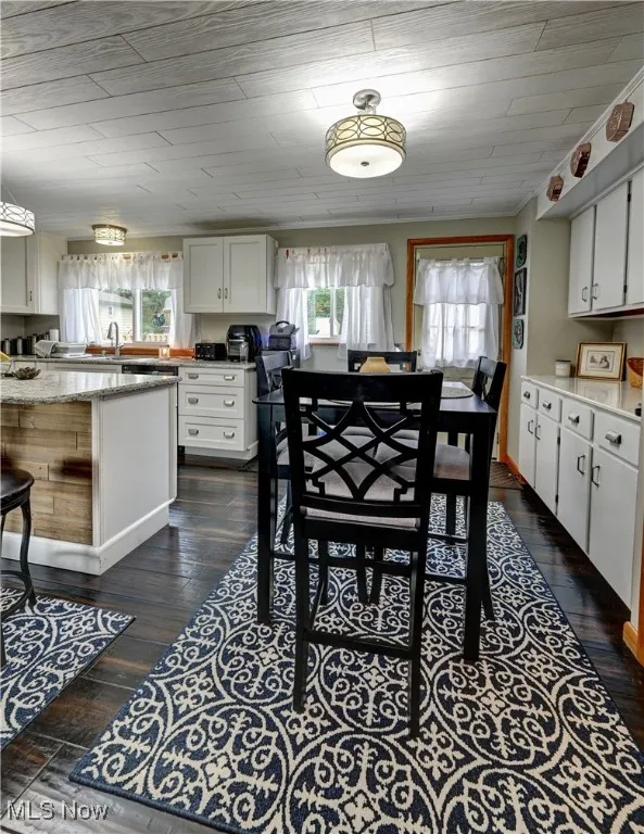 Dining space featuring dark wood-style flooring