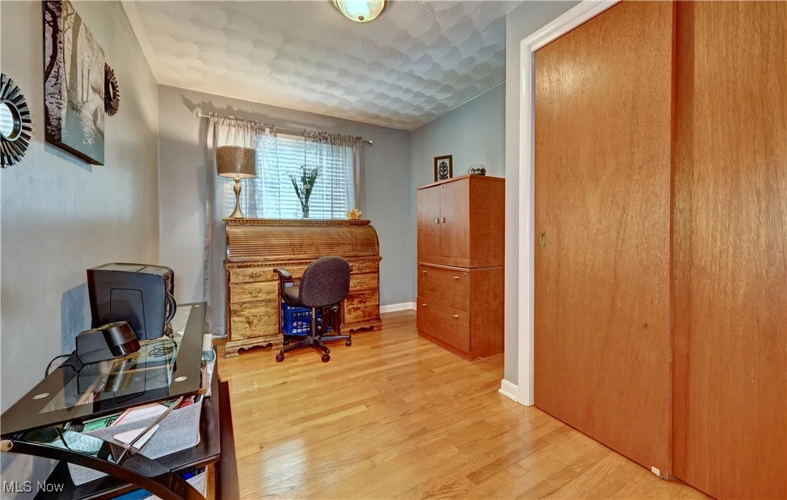 Office space with wood finished floors and baseboards