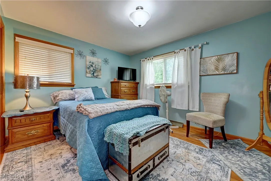 Bedroom with light wood-style flooring and baseboards