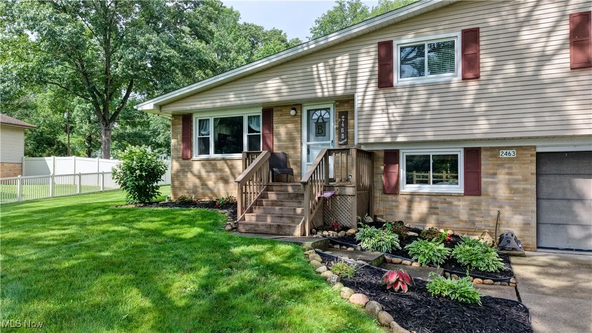 Split level home with brick siding and an attached​​‌​​​​‌​​‌‌​‌‌​​​‌‌​‌​‌​‌​​​‌​​ garage