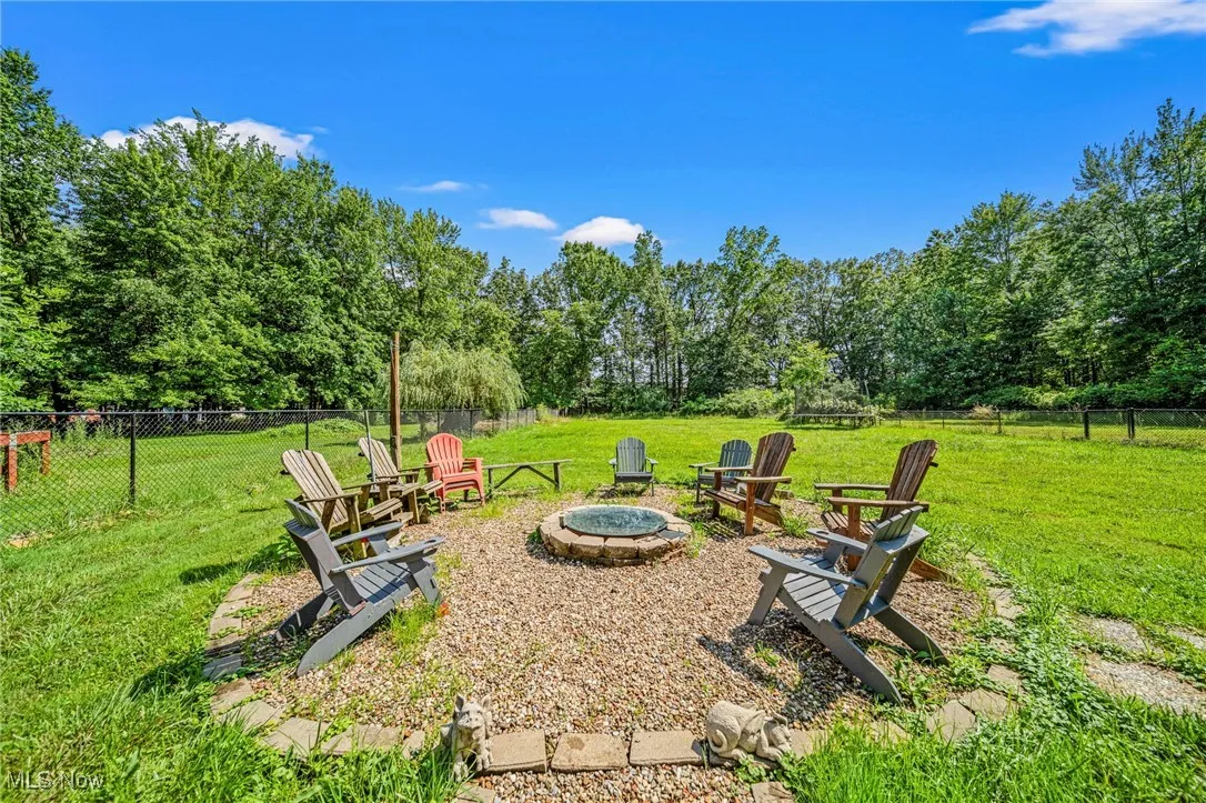 View of yard featuring an outdoor fire pit