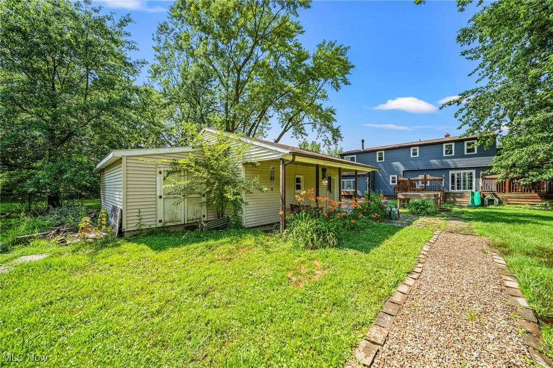 Rear view of property with a yard and a deck