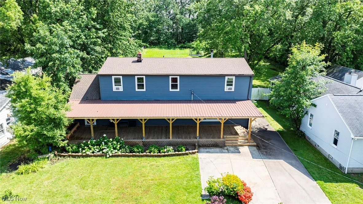 View of front facade featuring a front lawn and covered porch