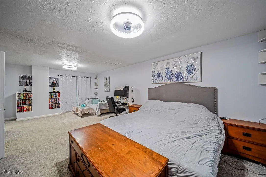Bedroom with carpet floors and a textured ceiling