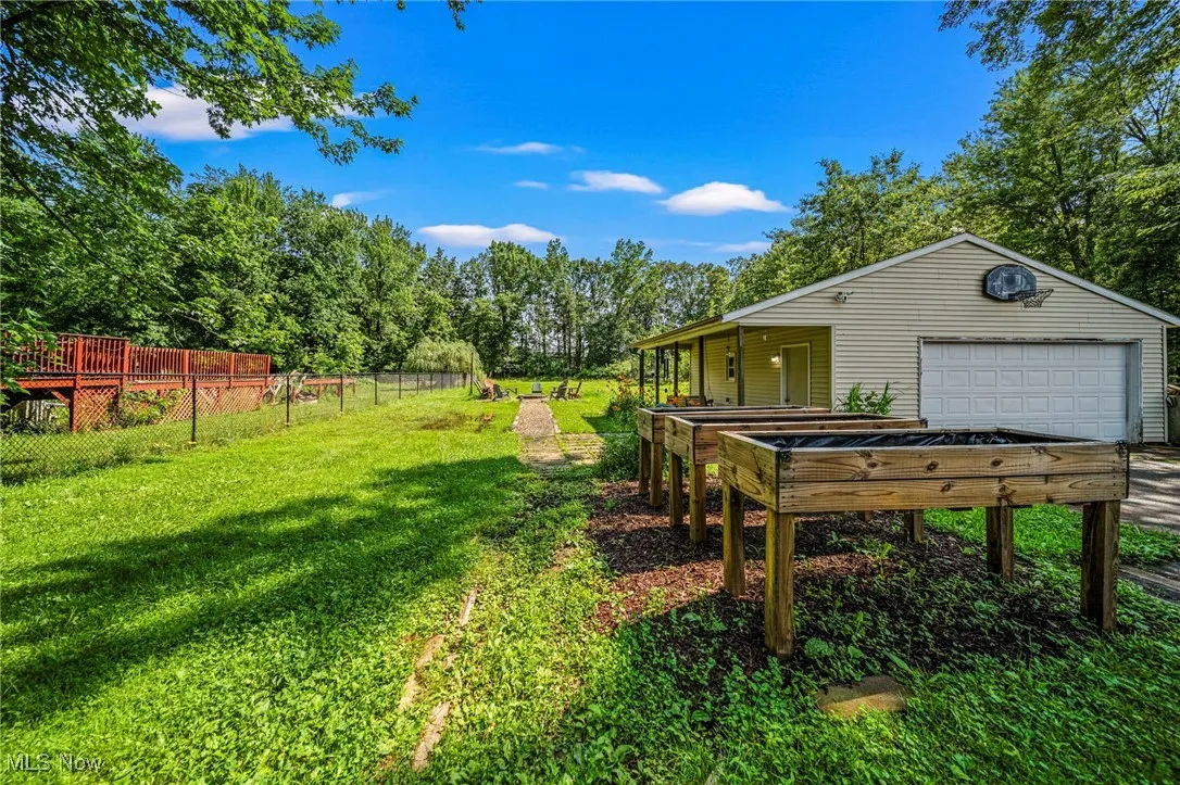 View of yard with a garage and an outdoor structure