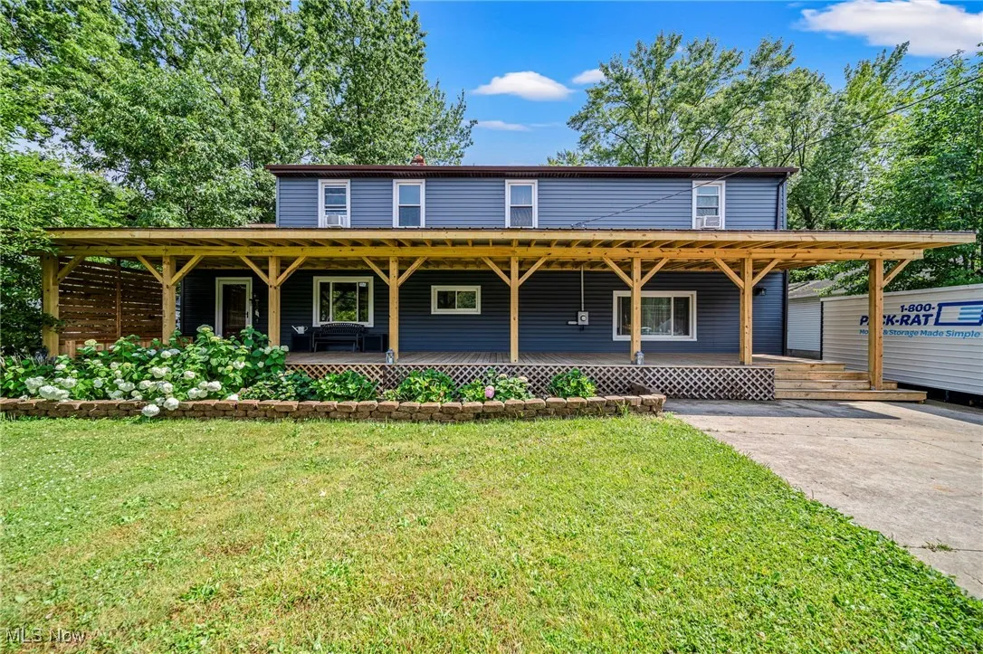 View of front facade featuring covered porch and a front lawn